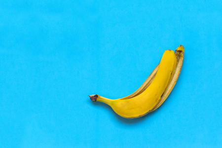 yellow skin of a banana against a blue background,  fruitの写真素材