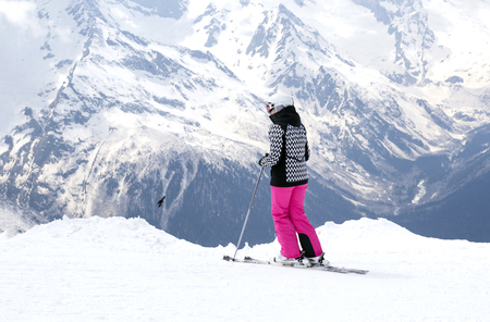 skier in ski equipment in the Caucasus mountains, ski resort in winter, snow peaks and slopesの写真素材