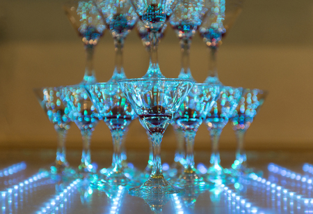 pyramid of wine glasses in a blue light, glasses of sparkling wineの写真素材