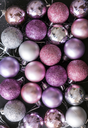 lot of pink and silver Christmas balls on a black background, Christmas decorationsの写真素材