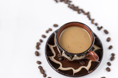 Cup of coffee with milk, coffee beans on a white background, hot drink