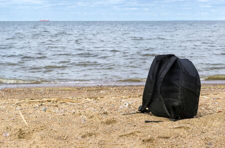 1 black backpack on the sand by the sea, Gulf of Finlandの写真素材