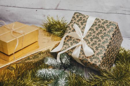 Christmas gifts, 3 gift boxes with ribbons, fir branch, tinselの写真素材