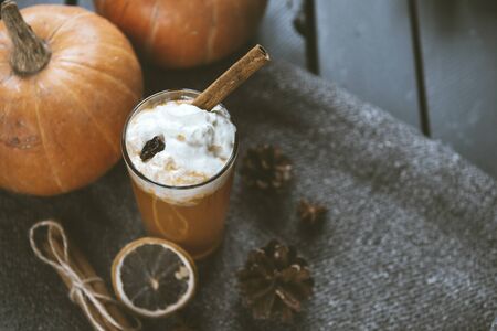 1 glass of pumpkin juice with cream and cinnamon, fresh whole pumpkins, autumn vegetable juice,の写真素材