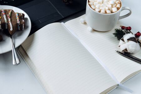 open notebook with a clean sheet, pen, Christmas tree shaped cookies, Cup of cocoa with...