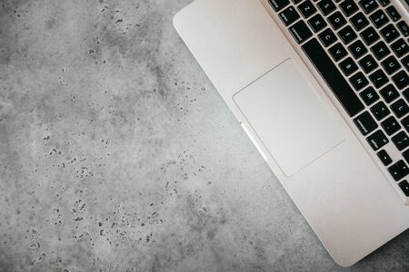keyboard laptop on a gray concrete background, the top view, 1 gadget,  copy space, flat lay