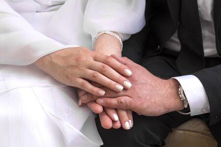 female and male hands together, couple, bride and groomの写真素材