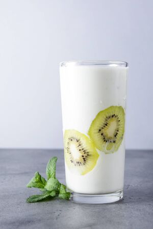 natural yoghurt with fresh kiwi  and mint on a grey backgroundの写真素材
