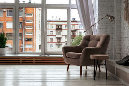 1 beige armchair in a bright room with a window backgroundの写真素材
