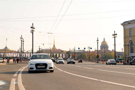 Saint Petersburg, cars drive along the road in the city against the background of buildings at sunset, editorial September 27, 2020,の写真素材