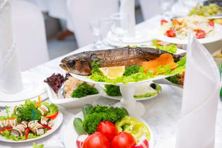 baked trout, cooked fish on the Banquet tableの写真素材
