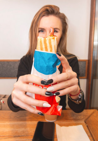 1 white woman holding a hot dogの写真素材