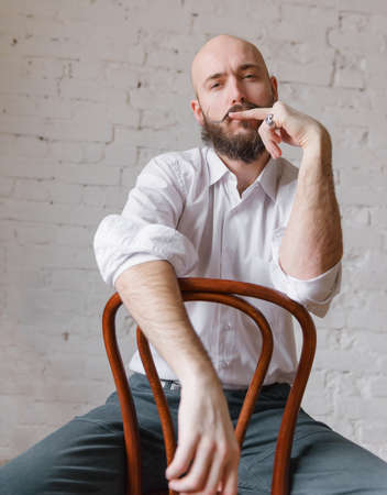 30 years old white bald man with a beard and mustache in a white shirt, young,