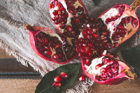 ripe red pomegranate on a napkin on a dark background top viewの写真素材