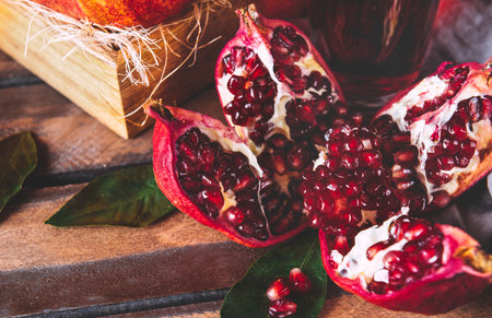 ripe red pomegranate on a napkin on a wood background top viewの写真素材