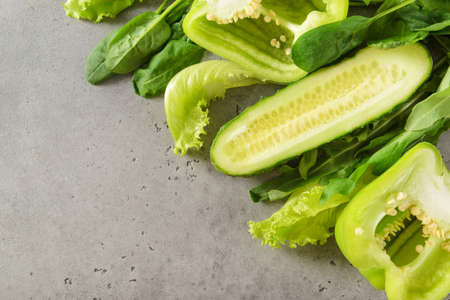 greens, lettuce, cucumber,   arugula, pepper on a gray background, green vegetable,の写真素材