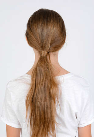 Young girl in white t-shirt model snap back look close up on white backgroundの写真素材