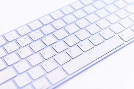 Keyboard purple keys white table central blur work office studyの写真素材