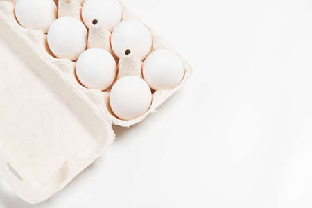 White eggs in cardboard on white background side look spring fresh productsの写真素材