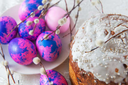 Easter cake with purple eggs and willow branches close spring festive holidays minimal horizontal