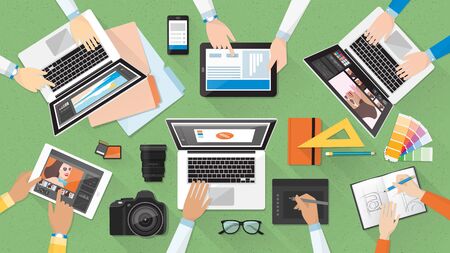 Creative team working together at office desk, teamwork and advertising conceptのイラスト素材