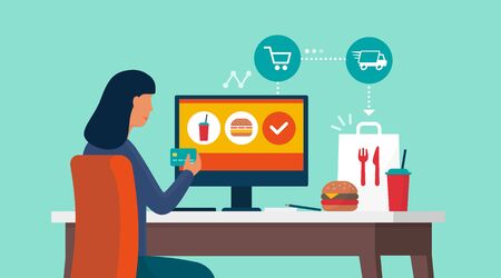 Woman connecting with her computer at home and ordering fast food at home, she is paying with a credit cardのイラスト素材