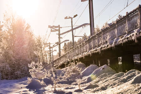 Snowed fence at railroad stationの写真素材