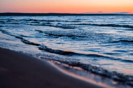 Waves on the shore of Ladoga lake at dawn. Beautiful sunrise landscapeの写真素材