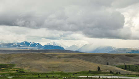 Altai mountains landscape. The mountain range behind the steppe and hillsの写真素材