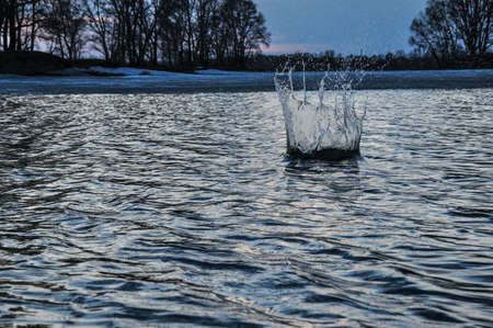 Water splash on the lake surface after a thrown stone