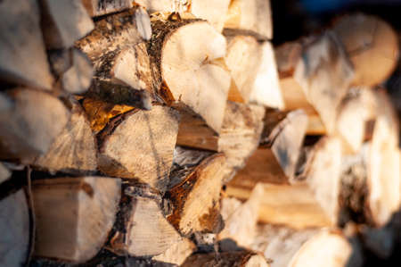 Stack of wirewood lit by sunlight. Close up