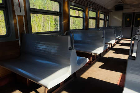 Interior of a suburban electric train in summer day. Saint-Petersburg