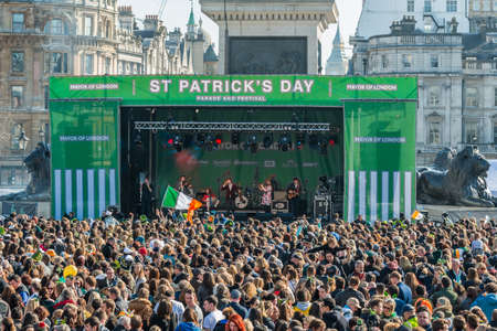 London, United Kingdom - March 13, 2016: St Patrick's Day Parade and Festival  at Trafalgar Square. Crowds of people are listening to a concert and dancing.のeditorial素材