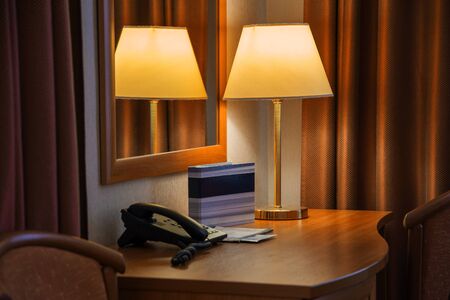 hotel room interior, table, lamp and mirrorの写真素材