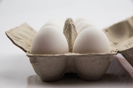 white chicken eggs on a white backgroundの写真素材