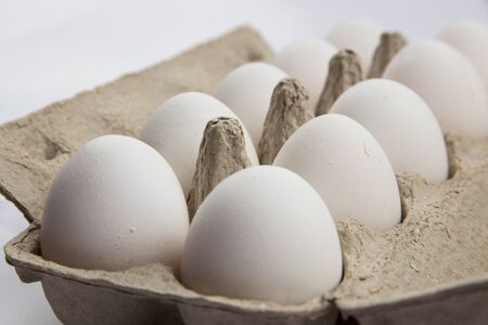 white chicken eggs on a white background