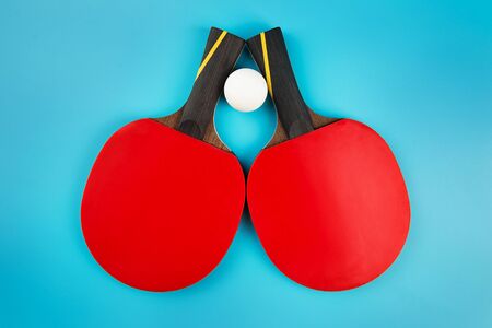 tennis rackets and a  ball on a blue backgroundの写真素材