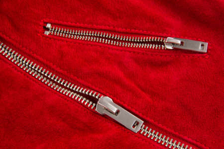 metal zipper on a red leather garment on a white background