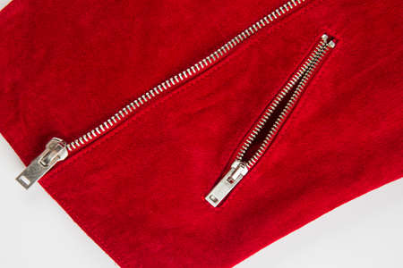 metal zipper on a red leather garment on a white backgroundの写真素材