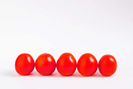 ripe vegetables, oval-shaped red tomatoes on a white background, isolateの写真素材