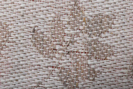 fabric made of linen and cotton fibers of jacquard weave, beige background, macro