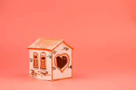 white patterned house-candle holder, ceramic souvenir on a pink backgroundの写真素材