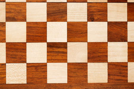 wooden chessboard with pieces and pawns in light and dark brown tones, isolate on a white backgroundの写真素材