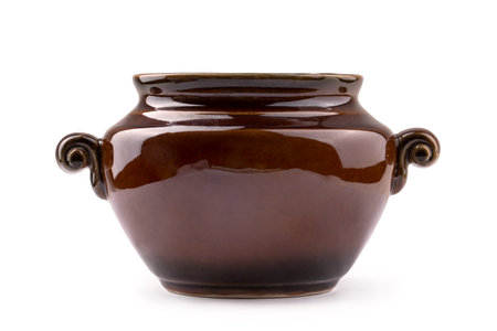 ceramic pot for baking vegetables and meat in the oven, isolate on a white backgroundの写真素材