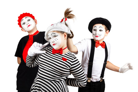 boys and a teenage girl in the image of a mime with makeup on her face, isolate on a white backgroundの写真素材