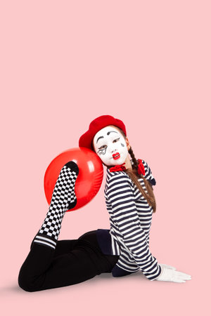 teenage girls in the image of mimes with makeup on their faces, isolate on a white backgroundの写真素材