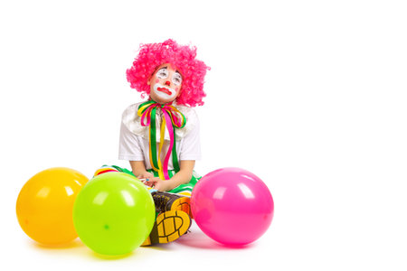 children in colorful clown outfits, isolated on a white backgroundの写真素材