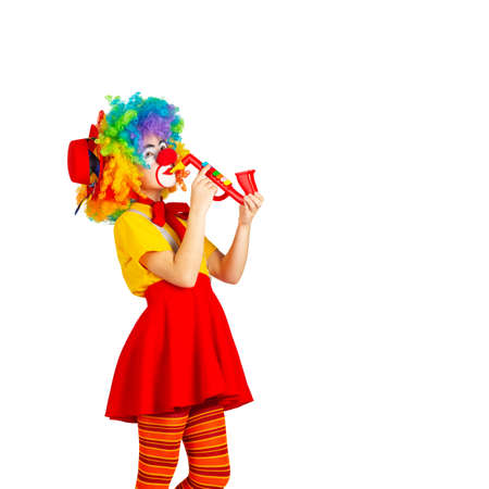 children in colorful clown outfits, isolated on a white backgroundの写真素材
