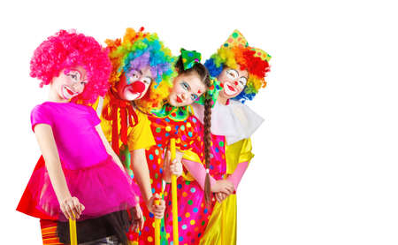 children in colorful clown outfits, isolated on a white backgroundの写真素材