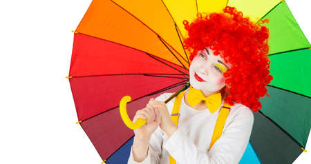 children in colorful clown outfits, isolated on a white backgroundの写真素材